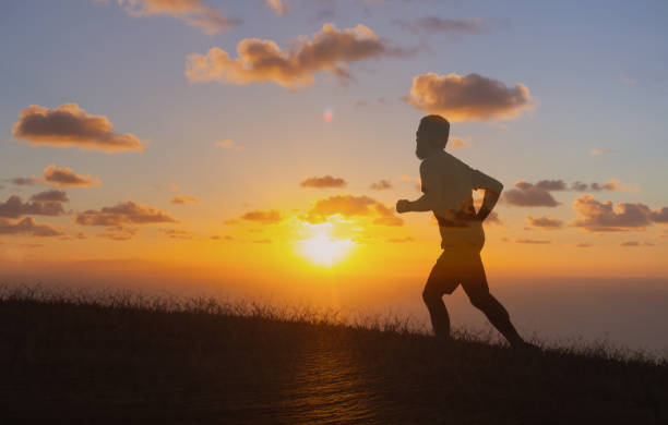 istock Man running in the sunset. 2120841986