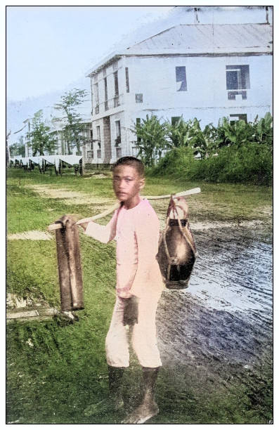 Antique black and white photograph of people from islands in the Caribbean and in the Pacific Ocean; Cuba, Hawaii, Philippines and others: Water carrier, Manila, Philippines