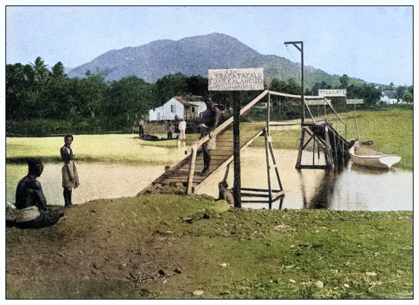 Antique black and white photograph of people from islands in the Caribbean and in the Pacific Ocean; Cuba, Hawaii, Philippines and others: Toll bridge near Apia, Samoa