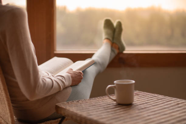 istock Woman having relaxing time with book and coffee. 2120857948