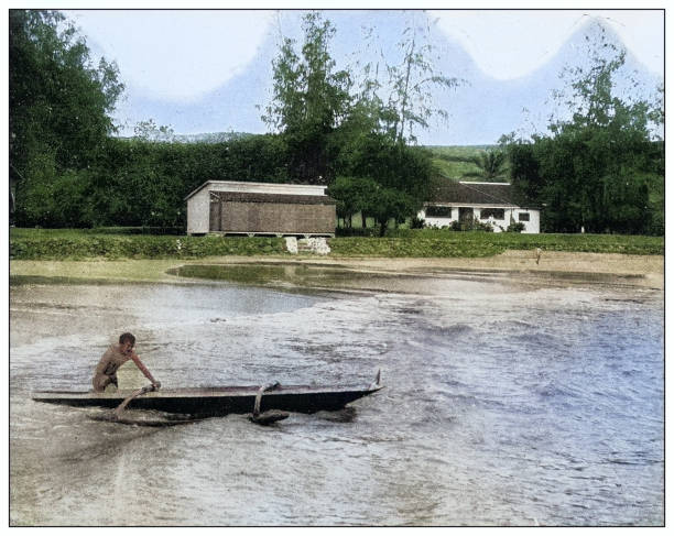 Antique black and white photograph of people from islands in the Caribbean and in the Pacific Ocean; Cuba, Hawaii, Philippines and others: Native on canoe, Makahuena, Kauai, Hawaii