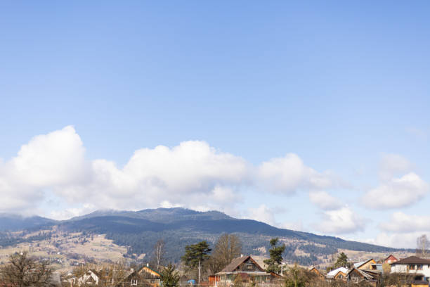 istock white clouds in the blue sky above the mountains 2120886272
