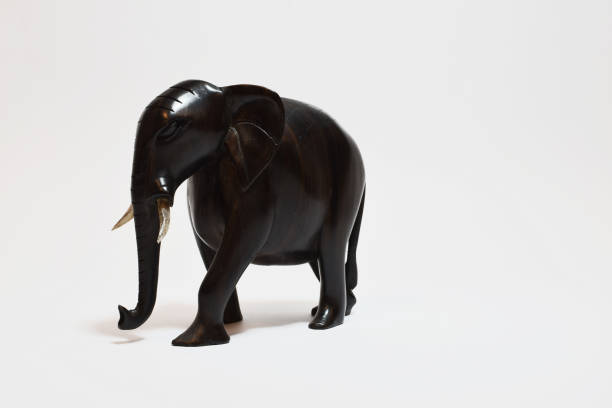 istock Elephant made of ebony wood in white background 2120896599