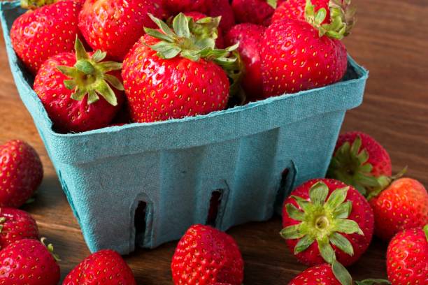 istock Close up overflowing quart basket of strawberries 2120936368
