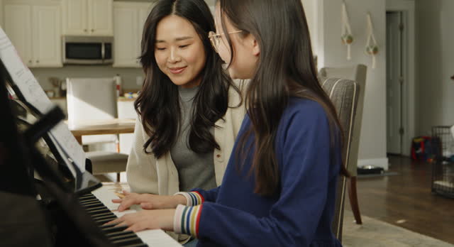 Piano Teacher and Student in a Home