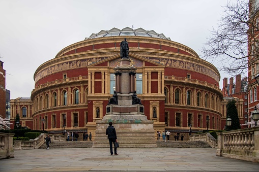 London, England - March 11, 2024: Man standing in front of the Royal Albert Hall