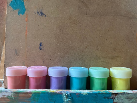 jars with paint of various colors