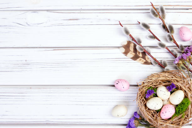 istock Easter banner with nest, eggs, willow, flowers and feathers. 2121018495