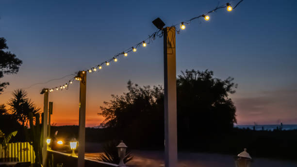 istock lamp light at sunset on the beach 2121033502