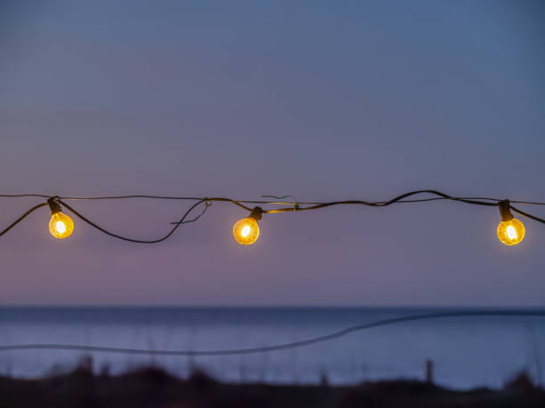istock lamp light at sunset on the beach 2121033506