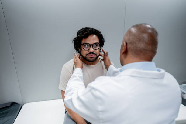 istock Doctor analyzing patient's jaw at medical clinic 2121045232