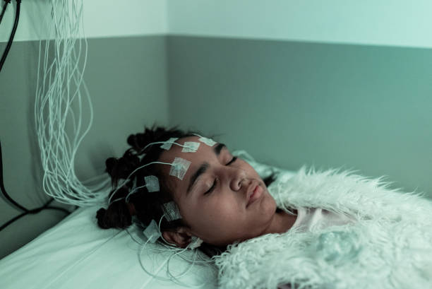 istock Child patient sleeping in a medical clinic doing polysomnography 2121052010