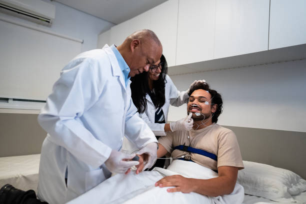 istock Doctors putting electrodes on patient at hospital 2121066541