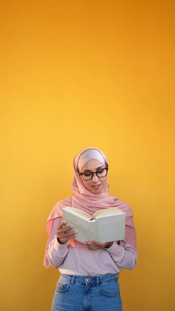 istock Book reading learning student delighted girl hijab 2121103184