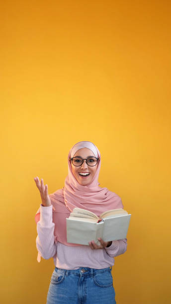 istock Surprised novel interesting reading amazed woman 2121103187