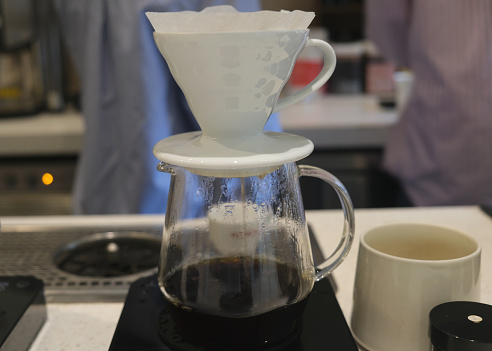 Close-up shot of the drip coffee filtration process. concept: coffee dripper, making coffee