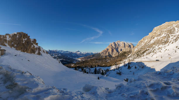 istock Idyllic view at dolomite mountain landscape during winter with snow covered peaks at pass road of Valparola, South Tirol, Italy 2121135643