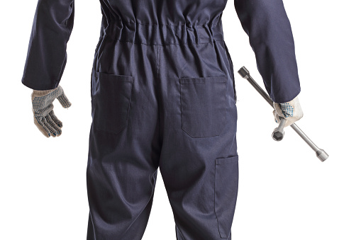 Rear view shot of a mechanic holding a lug wrench isolated on white background