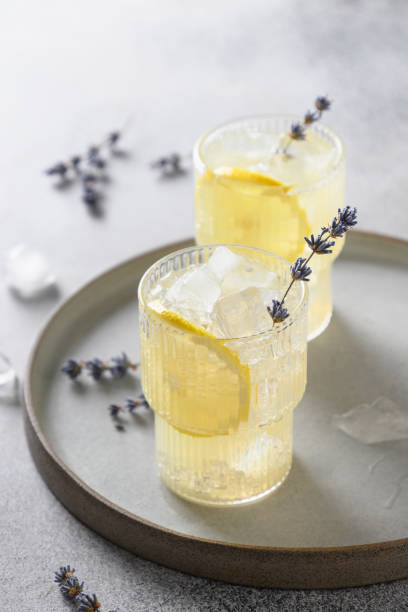 istock Sparkling summer lavender lemonade in glasses on gray background. 2121220328