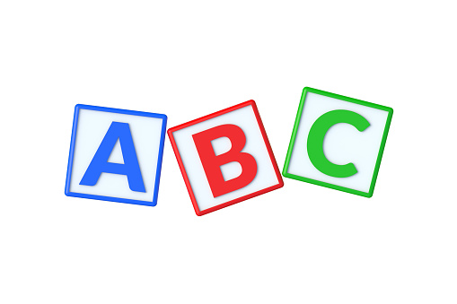 Letter A on wooden cube on a book shelf.