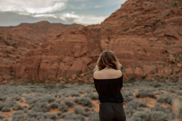istock Off the Shoulder Black Top Model Exploring Snow Canyon 2121251503