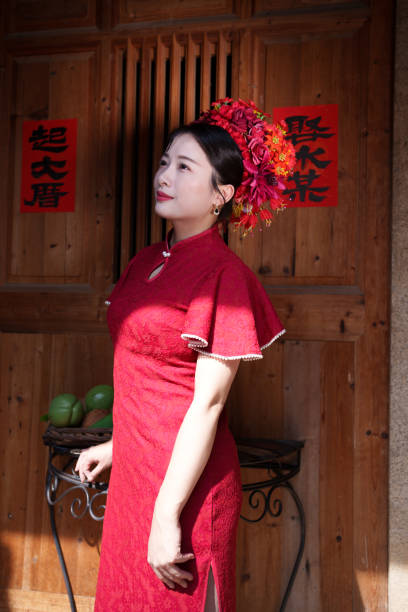 istock woman with red head flower 2121283258