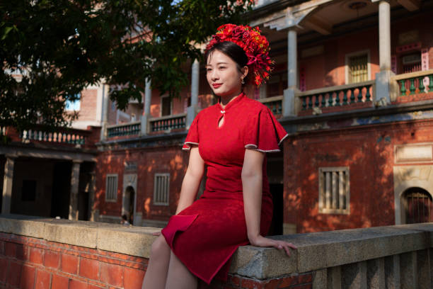istock Beautiful woman sitting on the wall 2121287424