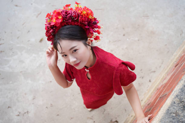 istock woman with red head flower 2121288467