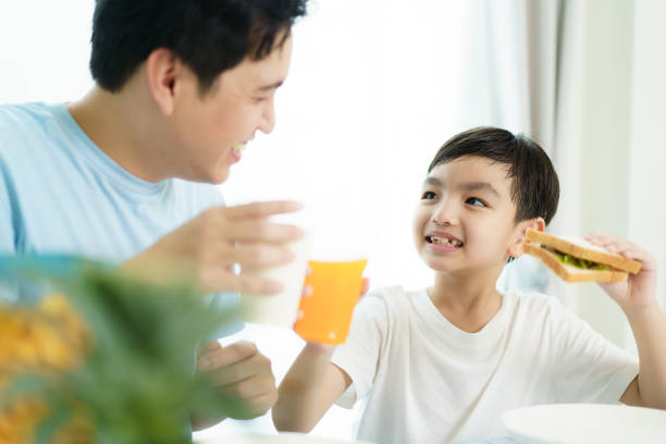 istock Father and son making a breakfast together. 2121353154