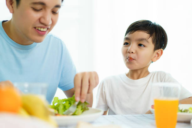 istock Father and son making a breakfast together. 2121353672
