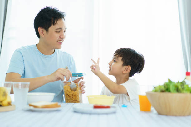 istock Father and son making a breakfast together. 2121354186