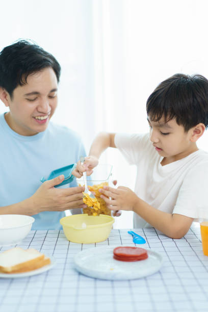 istock Father and son making a breakfast together. 2121354195