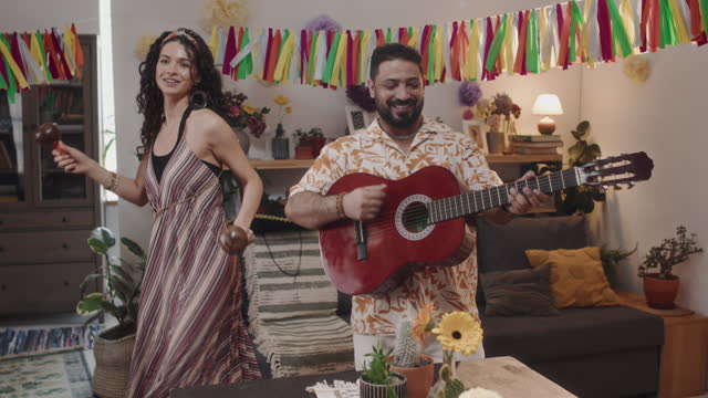 Cheerful Mexican People Singing and Dancing at Party in Family Home