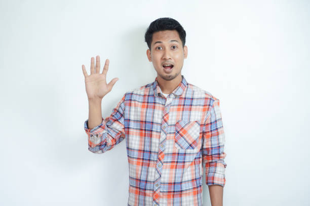 istock Asian man smiling happy while giving five finger up symbol 2121397015