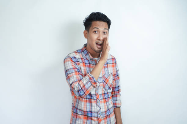 istock Adult Asian man doing whisper gesture isolated white background 2121407938