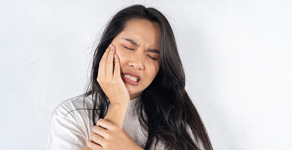 Face expression suffering from sensitive teeth and cold, asian young woman, girl feeling hurt, pain touching cheek, mouth with hand. Toothache molar tooth, dental problem isolated on white background.