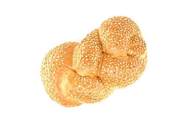 Decorated bread rolls on gray striped napkin on wooden table
