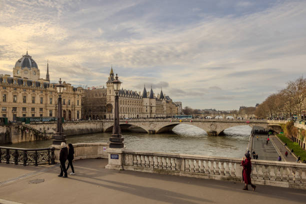 View of Tribunal de Commerce de Paris and Tour de l'Horloge du Palais de la Cité from the top deck of a hop-on hop-off Tootbus when crossing over Pont Notre-Dame in Paris, France, on Christmas Eve 2023