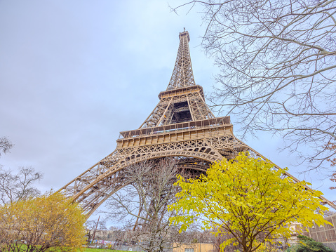 Eiffel Tower in Paris, France, on Christmas Day 2023, with fall foliage as well as leafless trees