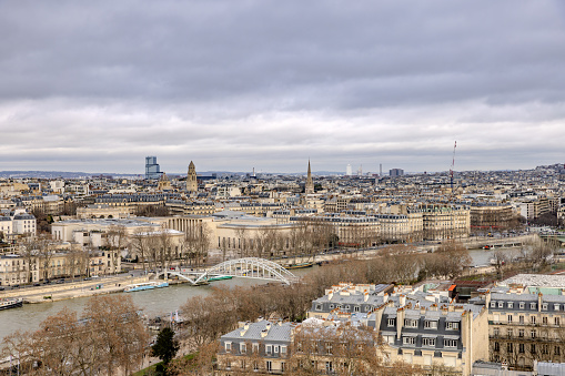 The views from the first floor of Eiffel Tower on a rainy and cloudy Christmas Day 2023, with Passerelle Debily arch bridge toward the front left