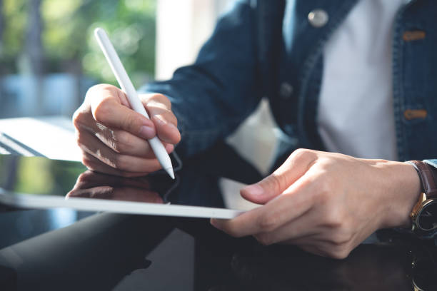 istock Close up, casual business woman using digital tablet, working at office with laptop computer on table. Young entrepreneur woman planning work project on tablet. Student online studying, e-learning 2121529677