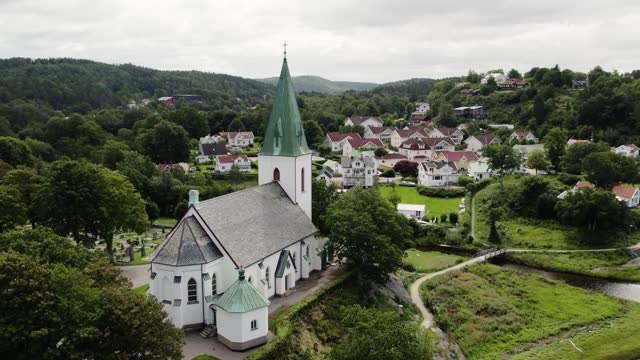 Ljungs Kyrka church of the Ljungskile parish, with green spire. Bohuslan - Sweden. Aerial.