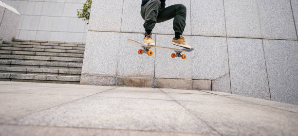 istock Skateboarder skateboarding in modern city 2121576575