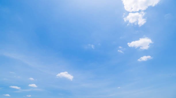 istock Panoramic view of clear blue sky and clouds, Blue sky background with tiny clouds. White fluffy clouds in the blue sky. Captivating stock photo featuring the mesmerizing beauty of the sky and clouds. 2121600056