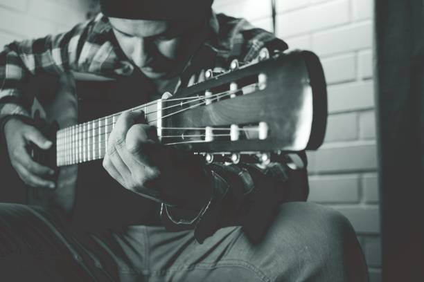 istock man practicing guitar, black and white photography 2121613471