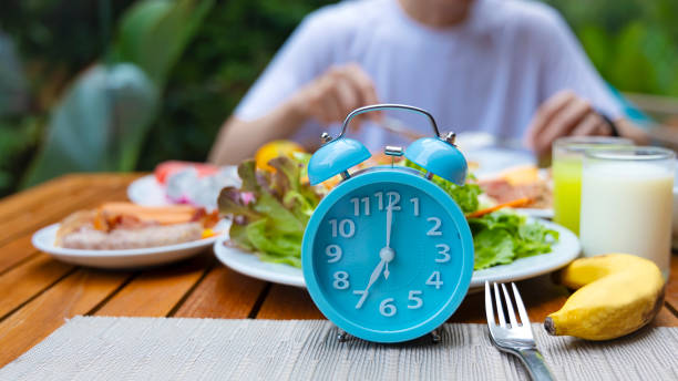 Alarm clock with IF (Intermittent Fasting) 16 and 8 diet rule and weight loss concept.-Diet plan concept