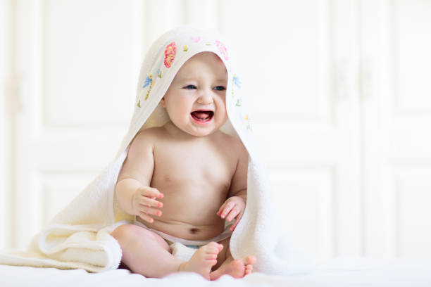 istock Little baby on white bed 2121634344