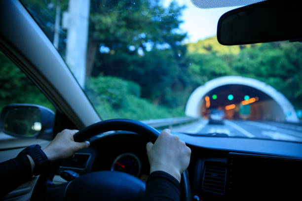 istock People driving car on city road 2121665179