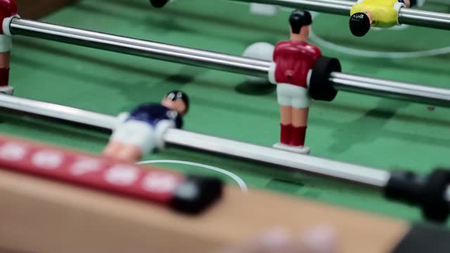close up of several people playing table football table football