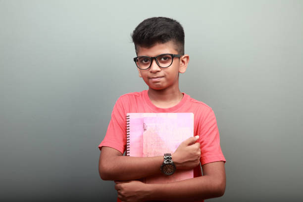 Portrait of a smart Indian boy holding a note book